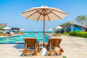 Beautiful umbrella and chair around swimming pool in hotel and r