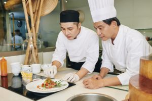 Chefs serving dish at the restaurant